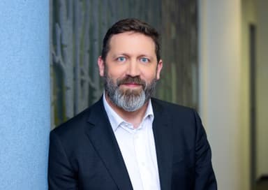 Mann in einem Anzug und Bart.